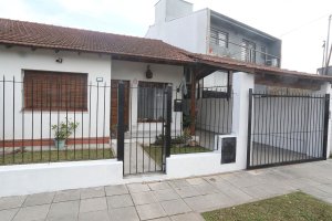 Duplex house for sale with garden and covered patio.